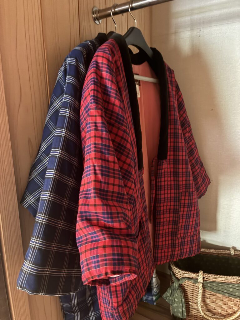 Yukata robes, hand towels, and a tea set arranged on a low wooden table inside the Yarimikan tatami room