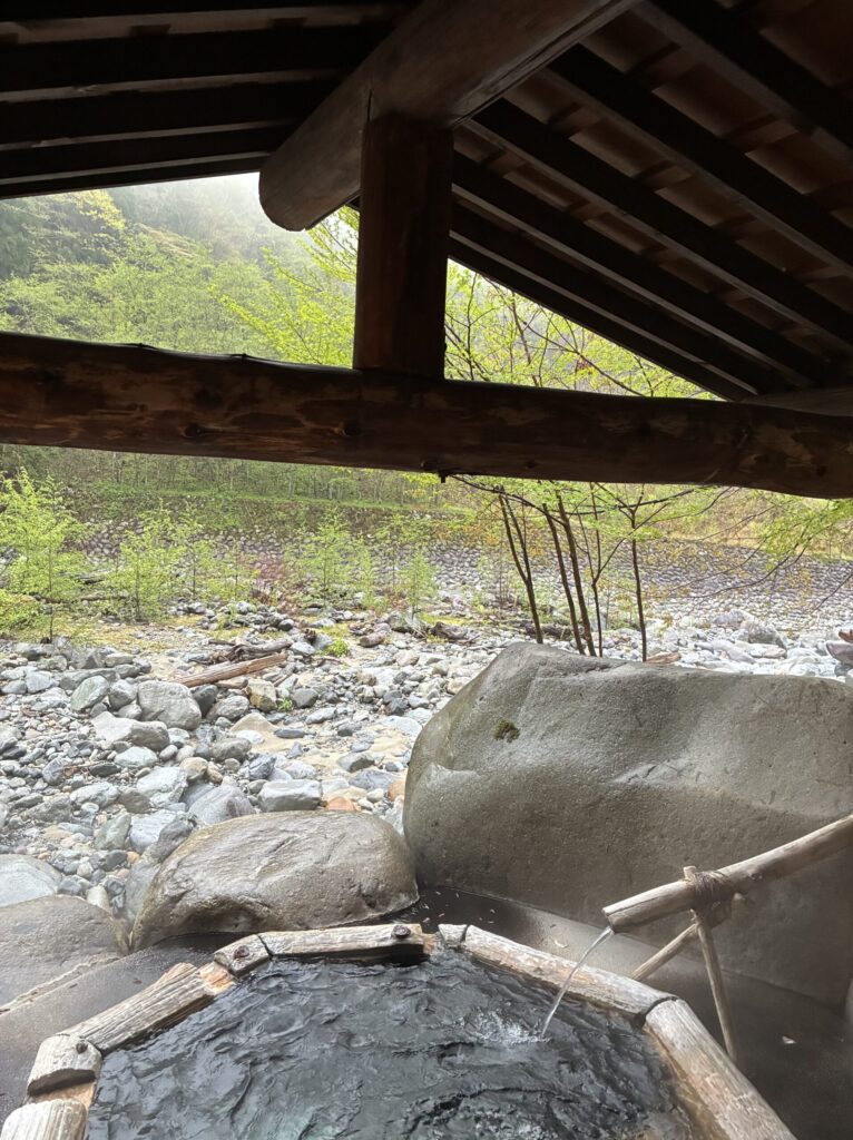 Stone path and lantern light leading to a private outdoor bath at Yarimikan ryokan in Okuhida