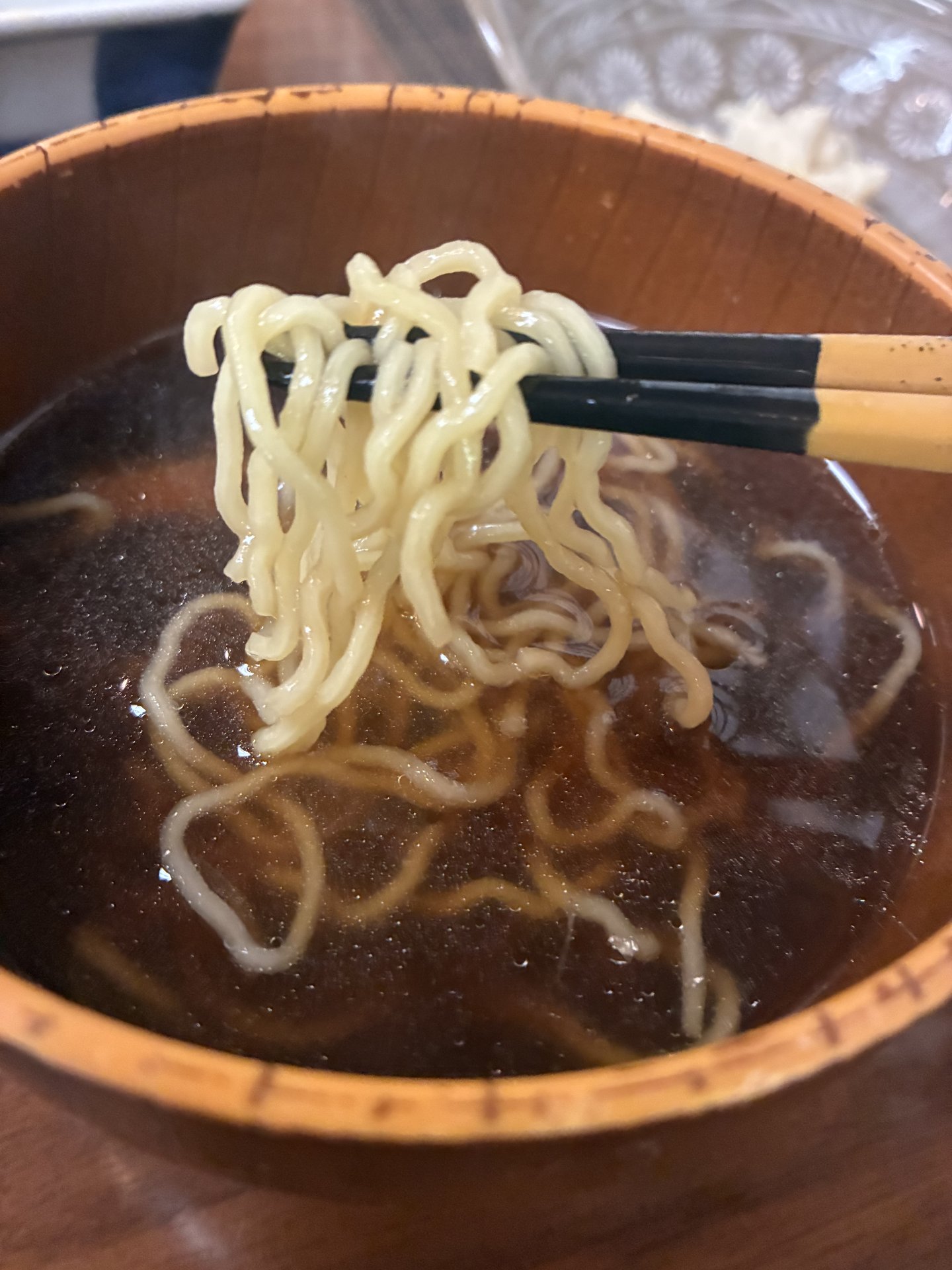 Takayama ramen with thin curly noodles in a clear soy-based broth served as a breakfast accent at Yarimikan