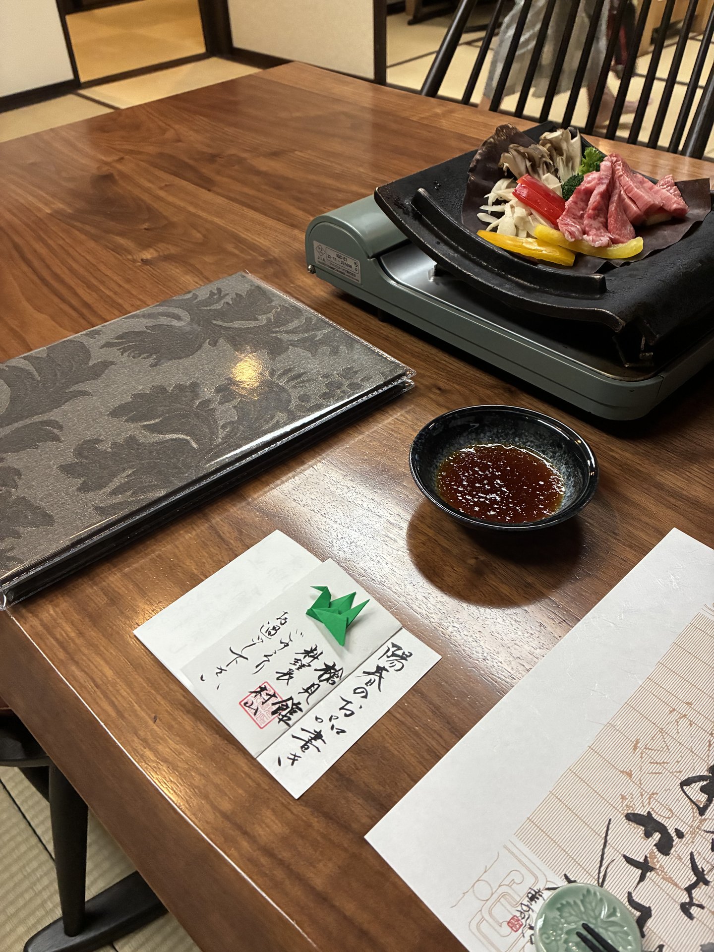 Hida beef hoba-yaki at Yarimikan ready to grill on a magnolia leaf with vegetables and dipping sauce at the table