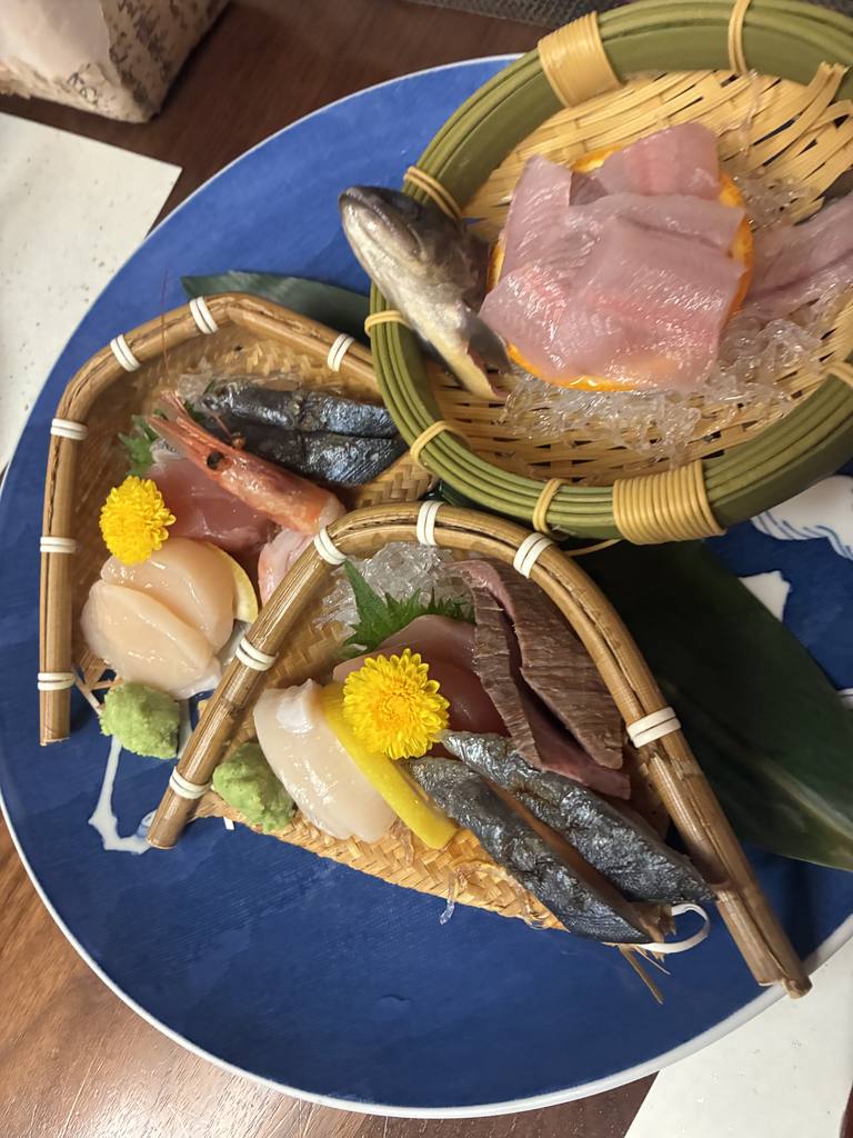 Night 2 sashimi service at Yarimikan: iwana river fish, sweet shrimp, scallop, and tuna arranged on bamboo boats over a large blue plate